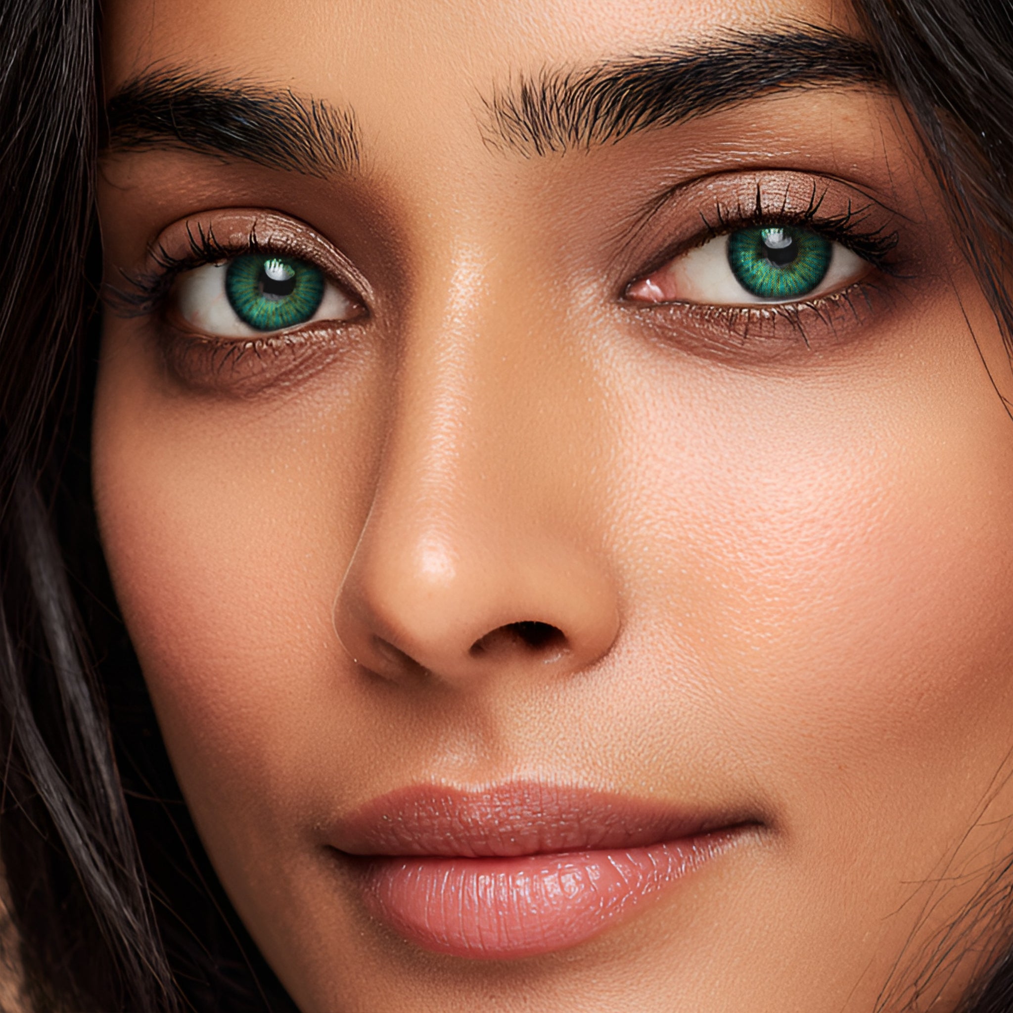 Close-up portraits of a model wearing MIIEMO Teal Aura Halation vibrant teal green glow contact lenses